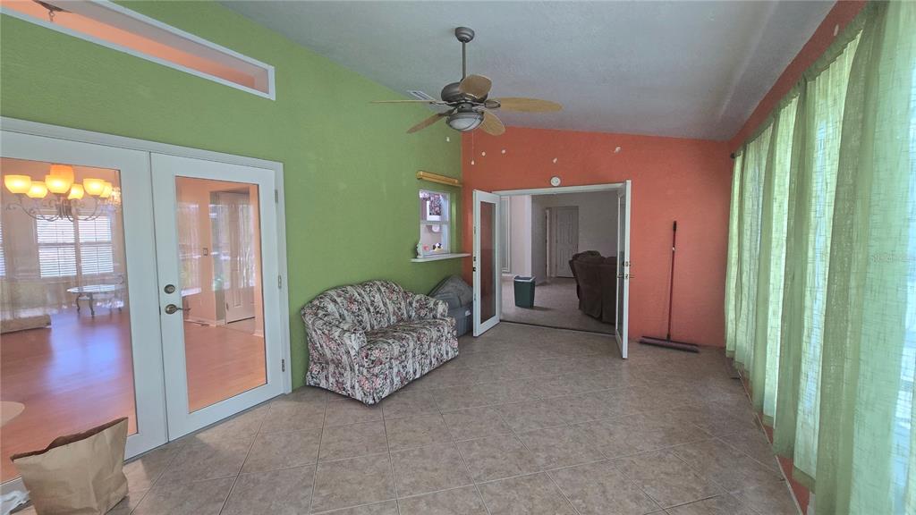 6501 Borg Street Leesburg, FL 34748 - Photo 43 of 59 a living room with furniture and a chandelier