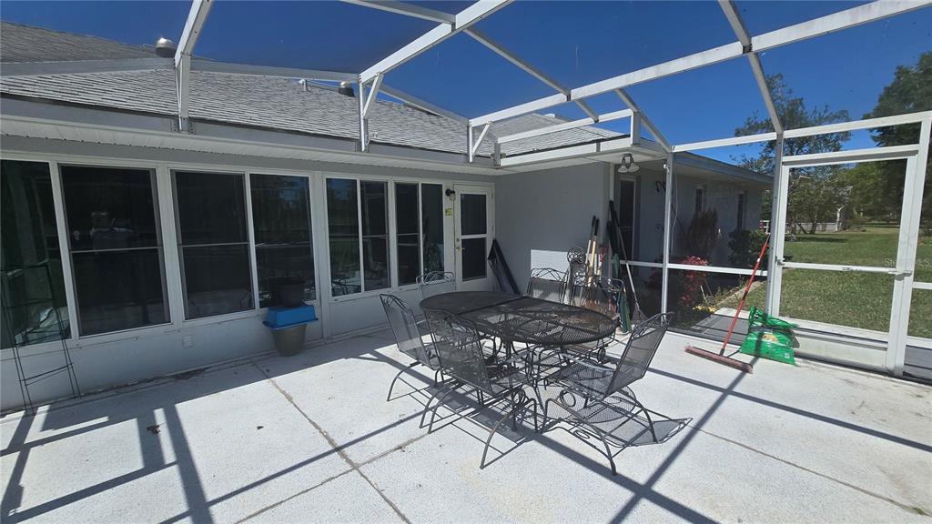 6501 Borg Street Leesburg, FL 34748 - Photo 45 of 59 a view of a patio with table and chairs and wooden floor