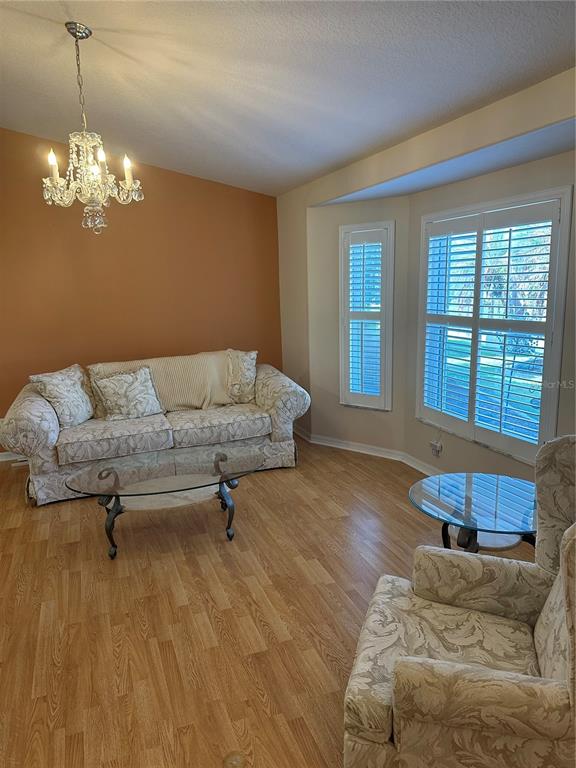 6501 Borg Street Leesburg, FL 34748 - Photo 7 of 59 a living room with furniture and a chandelier