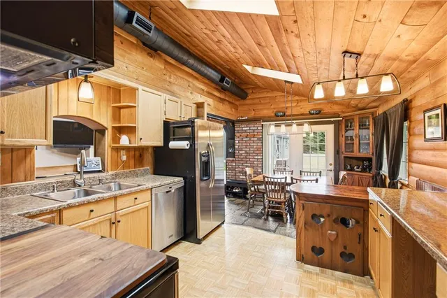a kitchen with stainless steel appliances granite countertop a sink stove and cabinets