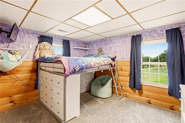 a bedroom with a large bed and a window