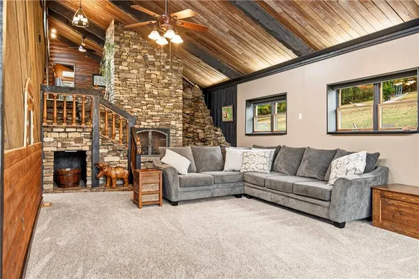 a living room with furniture a fireplace and a chandelier