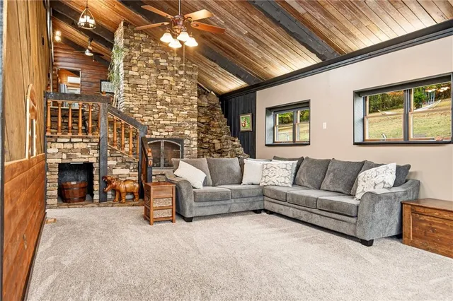 a living room with furniture a fireplace and a chandelier