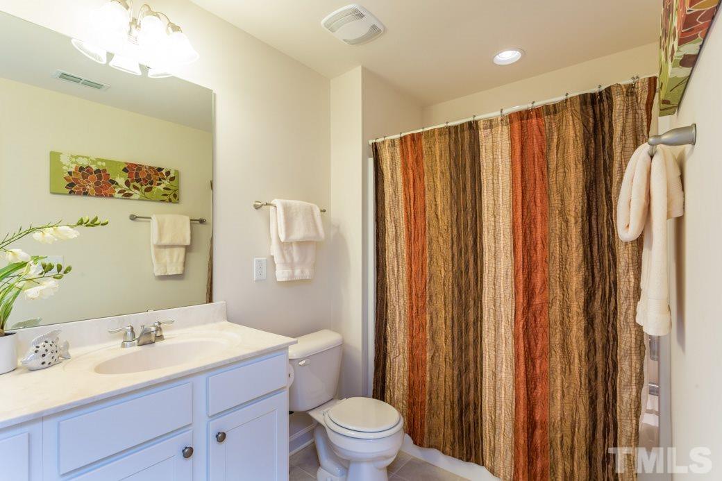 2458 Pecan Ridge Way Apex, NC 27502 - Photo 12 of 14 Double sinks in the secondary hall bath complete with tile floors and tub/shower combo.