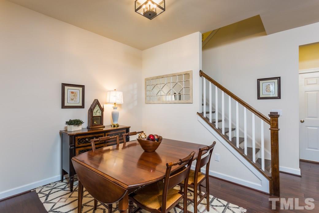 Large dining room with hardwood floors and lighting.