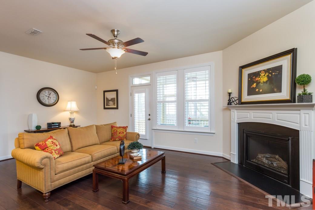 Ample size living room complete with fireplace and mantle.  Plantation shutters all downstairs.