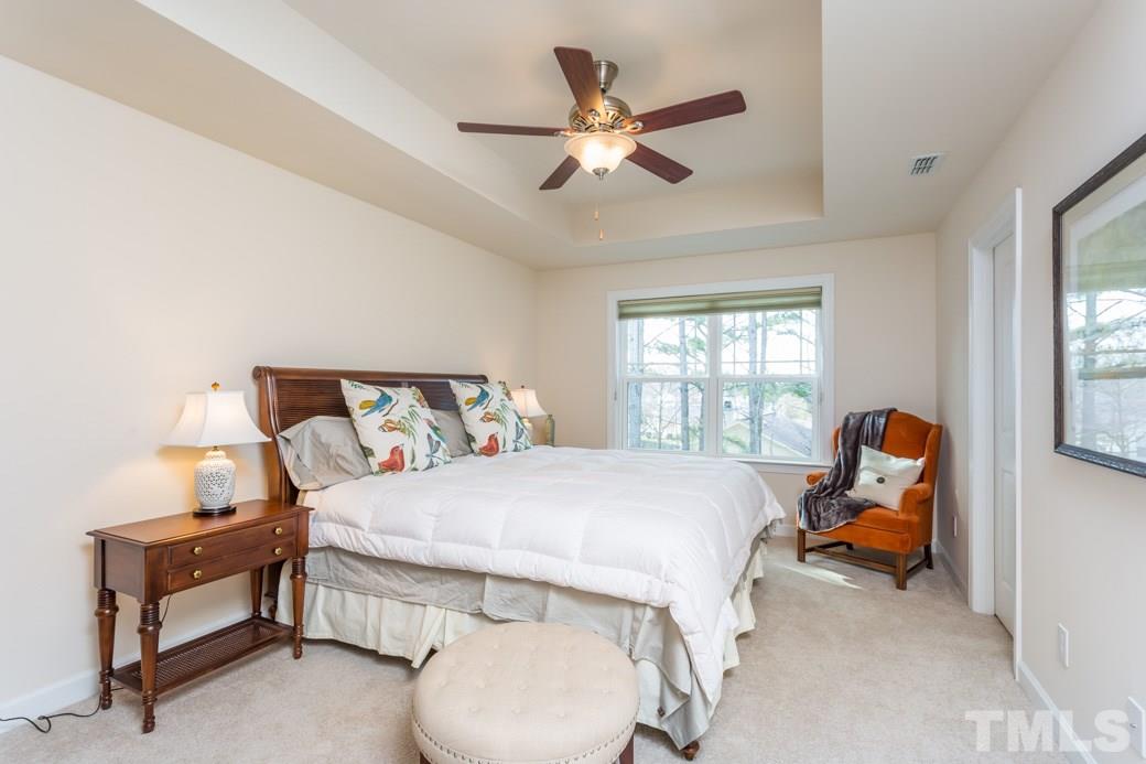 2458 Pecan Ridge Way Apex, NC 27502 - Photo 8 of 14 Large bright Master bedroom complete with tray ceiling, ceiling fan and custom shades.