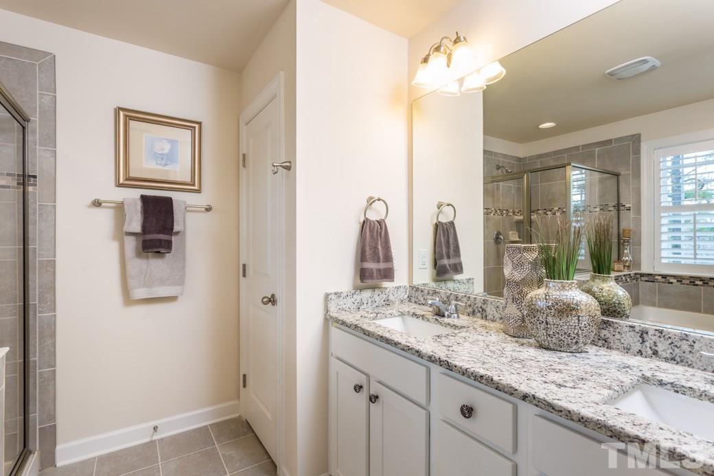 2458 Pecan Ridge Way Apex, NC 27502 - Photo 9 of 14 Deluxe master bath with Granite counters, tile surround on soaking tub, large tiled shower with decorator inlay.