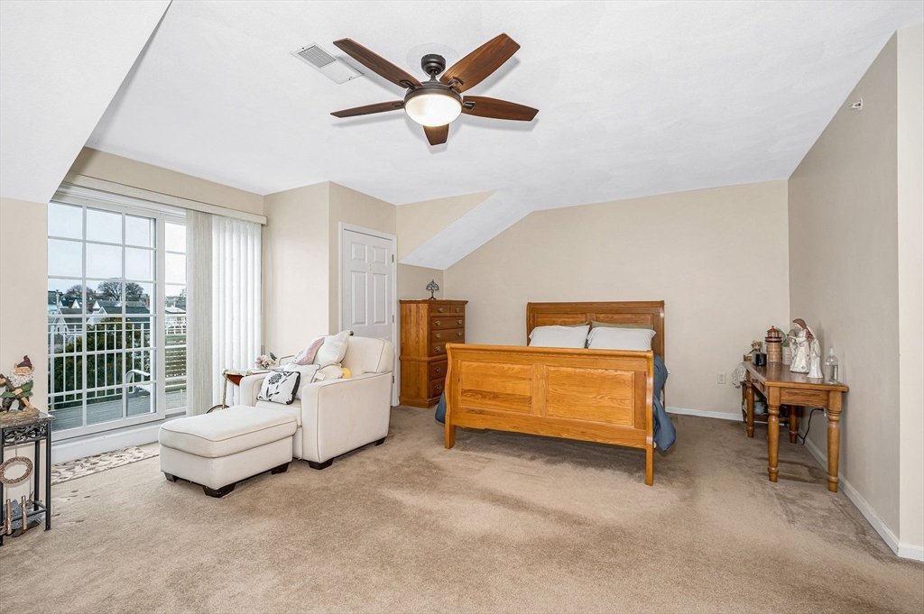 39 Broadway, Unit 305 Malden, MA 02148 - Photo 17 of 36 a spacious bedroom with a bed and a couch