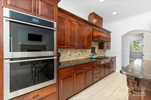 a dining room with furniture a chandelier and wooden floor