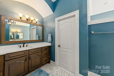 a bathroom with a sink vanity and a mirror
