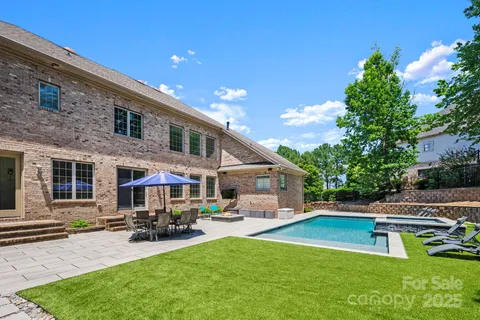 a view of a house with swimming pool and sitting area
