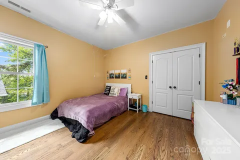 a spacious bathroom with a toilet sink and mirror