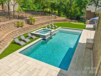 a view of a house with a yard and sitting area
