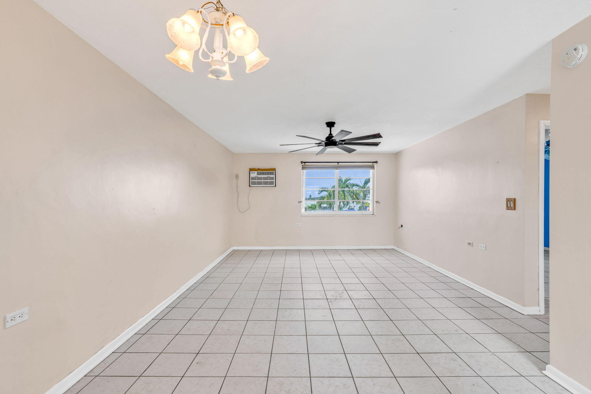 5301 Ocean Terrace, Unit 6 Marathon, FL 33050 - Photo 14 of 38 an empty room with windows and chandelier fan