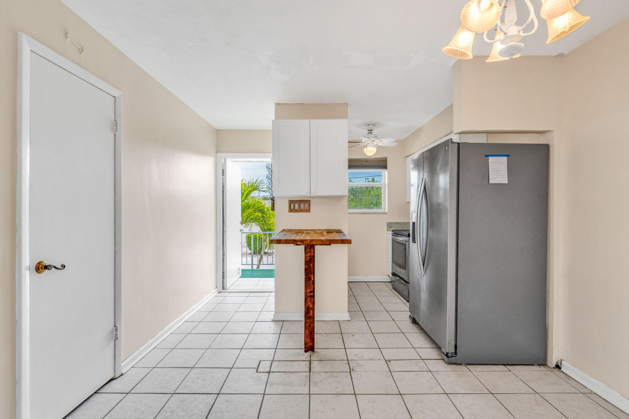 5301 Ocean Terrace, Unit 6 Marathon, FL 33050 - Photo 18 of 38 a kitchen with stainless steel appliances granite countertop a refrigerator and a stove top oven