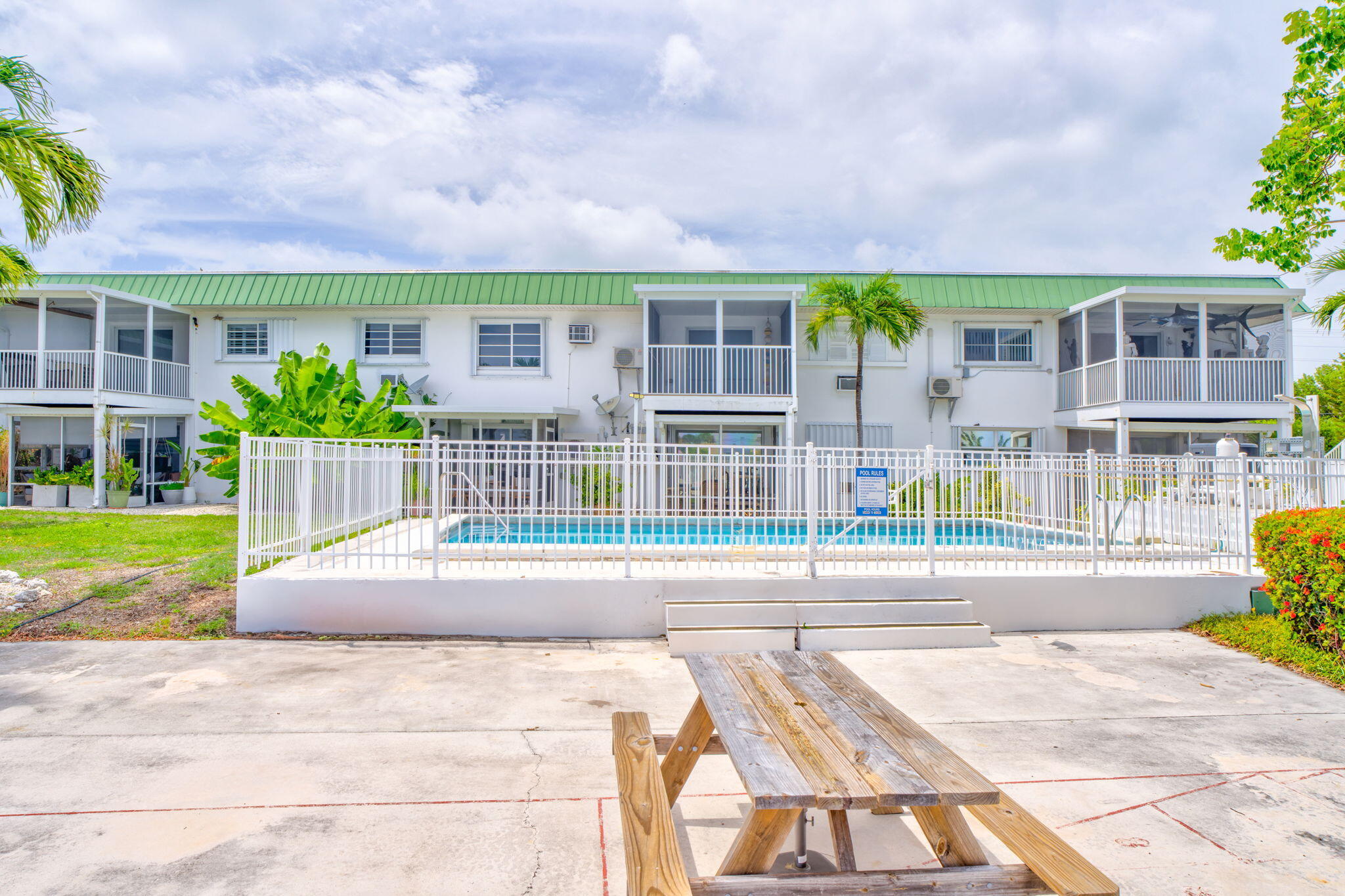 5301 Ocean Terrace, Unit 6 Marathon, FL 33050 - Photo 36 of 38 a front view of a house with a yard table and chairs