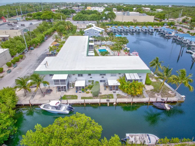 an aerial view of a house with swimming pool lake view and boat
