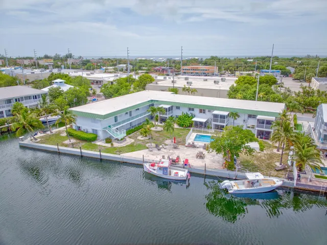an aerial view of a house with a garden and lake view