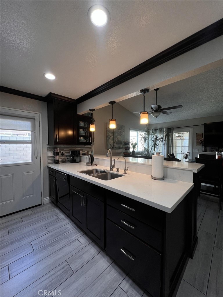 591 North Smoke Tree Avenue Rialto, CA 92376 - Photo 11 of 48 a kitchen with kitchen island a sink appliances and cabinets