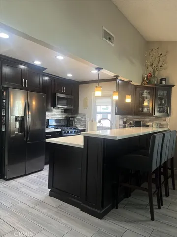 a kitchen with a sink cabinets and stainless steel appliances