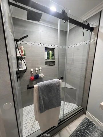 a bathroom with a shower and a sink