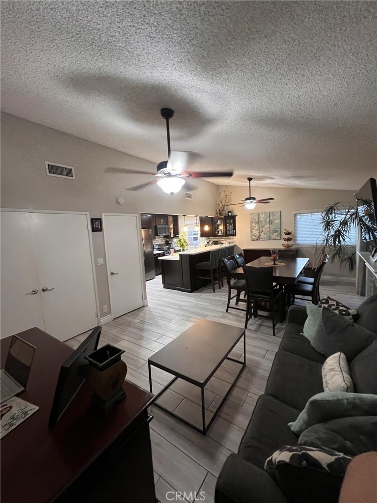 591 North Smoke Tree Avenue Rialto, CA 92376 - Photo 19 of 48 a living room with lots of furniture and view of kitchen