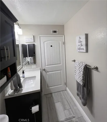 a bathroom with a sink toilet and mirror