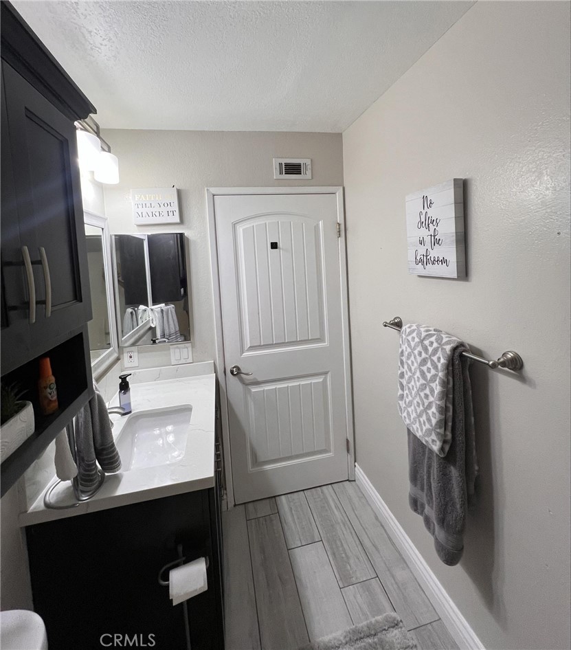 591 North Smoke Tree Avenue Rialto, CA 92376 - Photo 23 of 48 a bathroom with a sink toilet and mirror