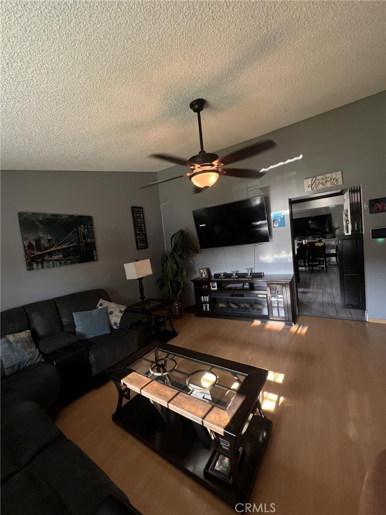 591 North Smoke Tree Avenue Rialto, CA 92376 - Photo 30 of 48 a living room with furniture and a flat screen tv