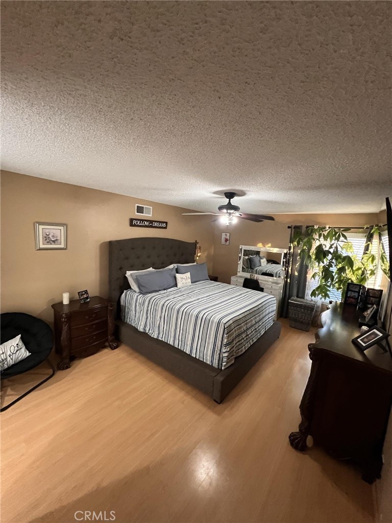 591 North Smoke Tree Avenue Rialto, CA 92376 - Photo 31 of 48 a spacious bedroom with a bed and a couch