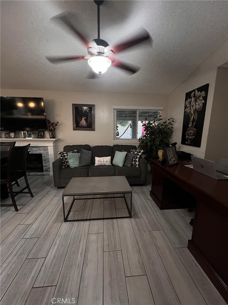 591 North Smoke Tree Avenue Rialto, CA 92376 - Photo 32 of 48 a living room with furniture and a wooden floor