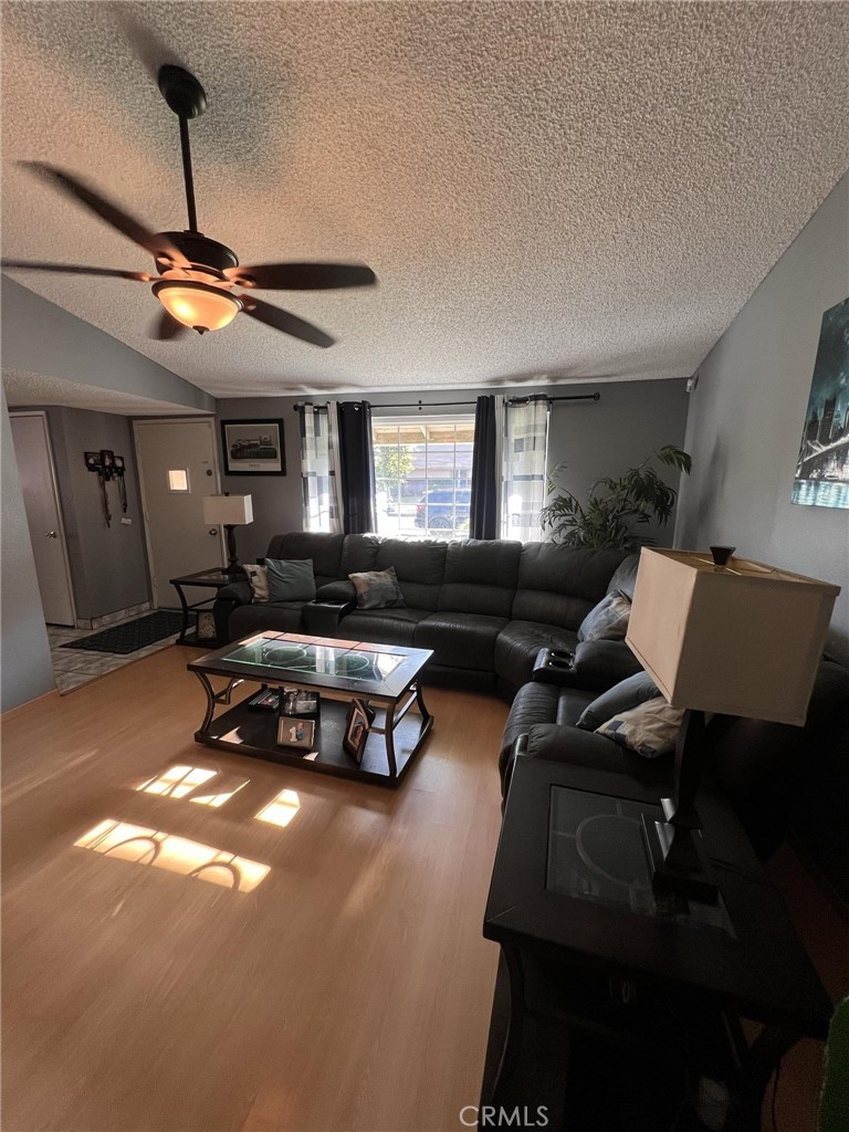 591 North Smoke Tree Avenue Rialto, CA 92376 - Photo 33 of 48 a living room with furniture a ceiling fan and a window