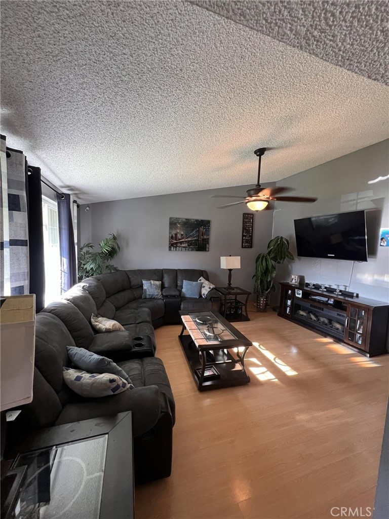 591 North Smoke Tree Avenue Rialto, CA 92376 - Photo 36 of 48 a living room with furniture and a flat screen tv
