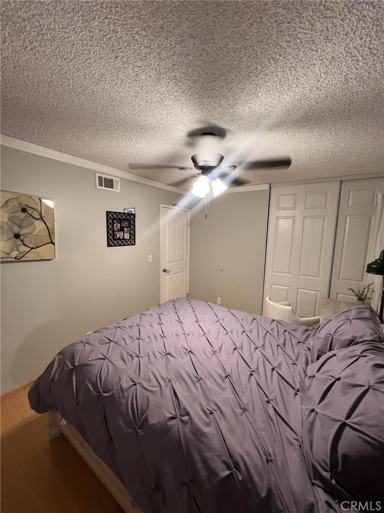 591 North Smoke Tree Avenue Rialto, CA 92376 - Photo 37 of 48 a bedroom with a bed and a chandelier