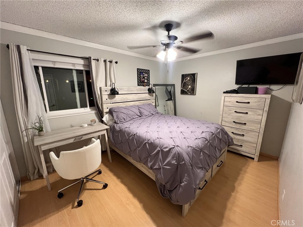 591 North Smoke Tree Avenue Rialto, CA 92376 - Photo 38 of 48 a bedroom with a bed tv and chair