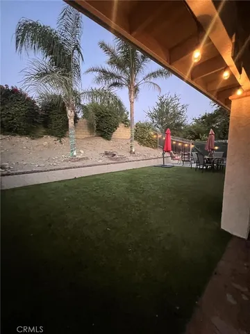 a view of a backyard with sitting area