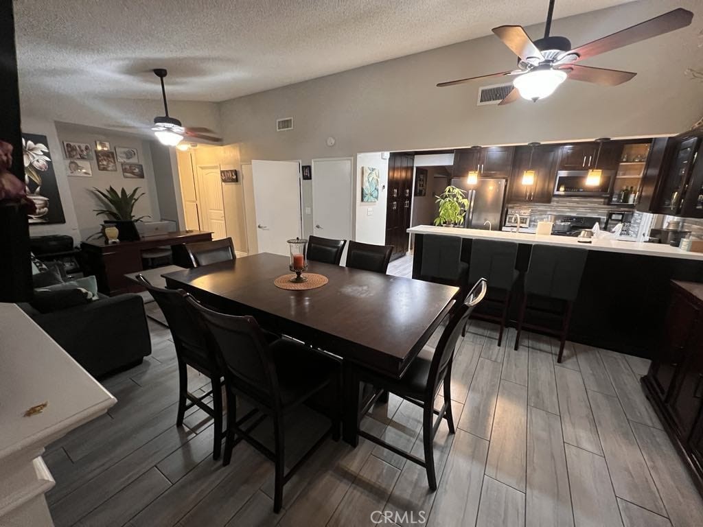 591 North Smoke Tree Avenue Rialto, CA 92376 - Photo 5 of 48 a view of a dining room with furniture and wooden floor