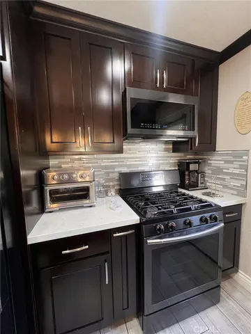 a kitchen with a stove and a microwave