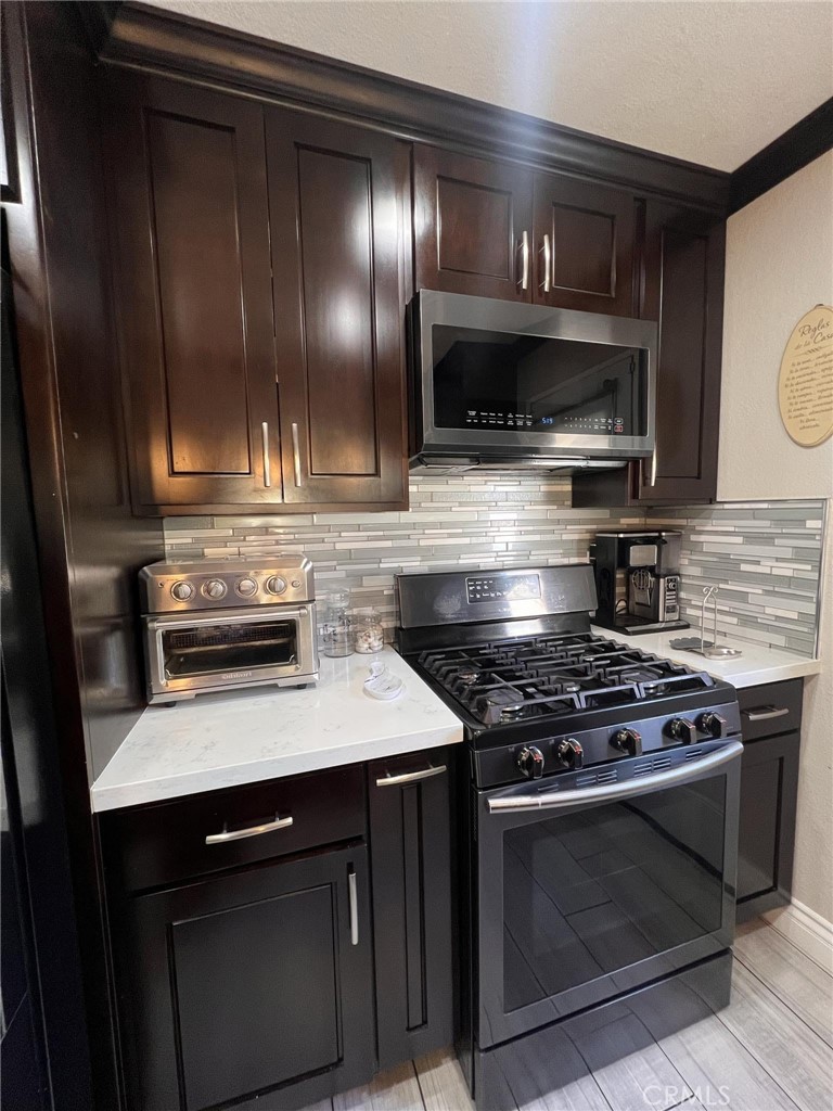 591 North Smoke Tree Avenue Rialto, CA 92376 - Photo 8 of 48 a kitchen with a stove and a microwave