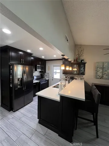 a large kitchen with a table and chairs