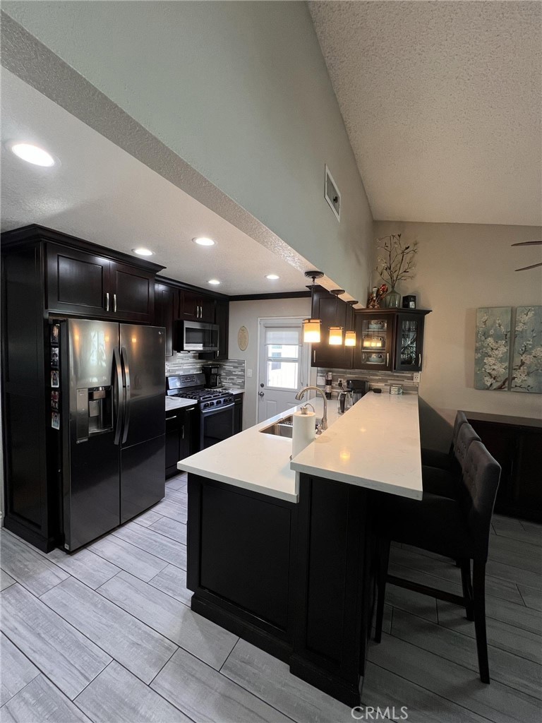 591 North Smoke Tree Avenue Rialto, CA 92376 - Photo 10 of 48 a large kitchen with a table and chairs