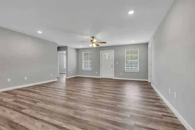 wooden floor in an empty room with a window