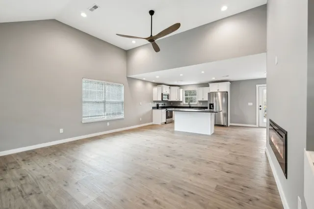 a view of a kitchen with a sink and a window