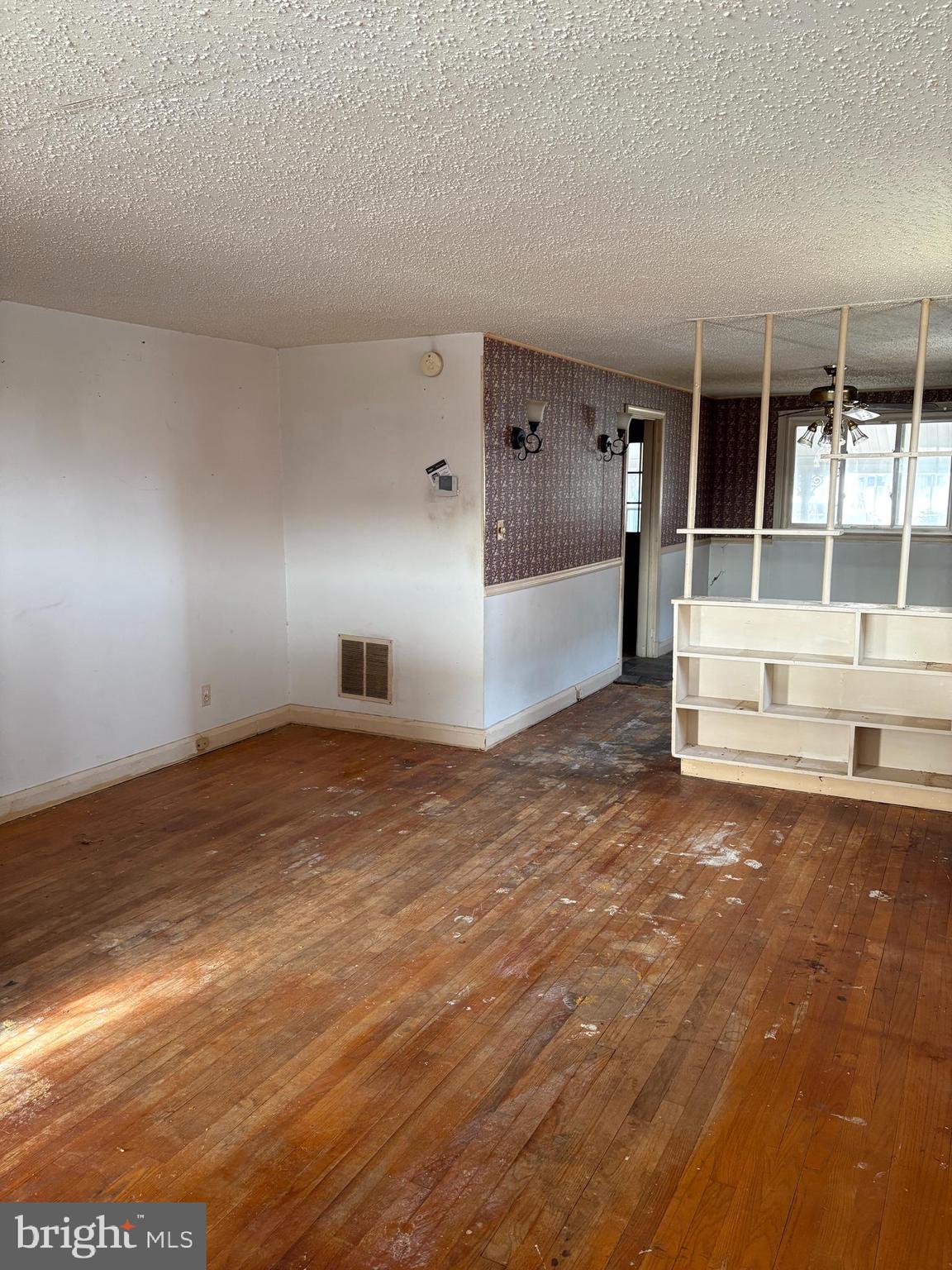 7832 Rockbourne Road Baltimore, MD 21222 - Photo 3 of 20 a view of a big room with wooden floor and windows