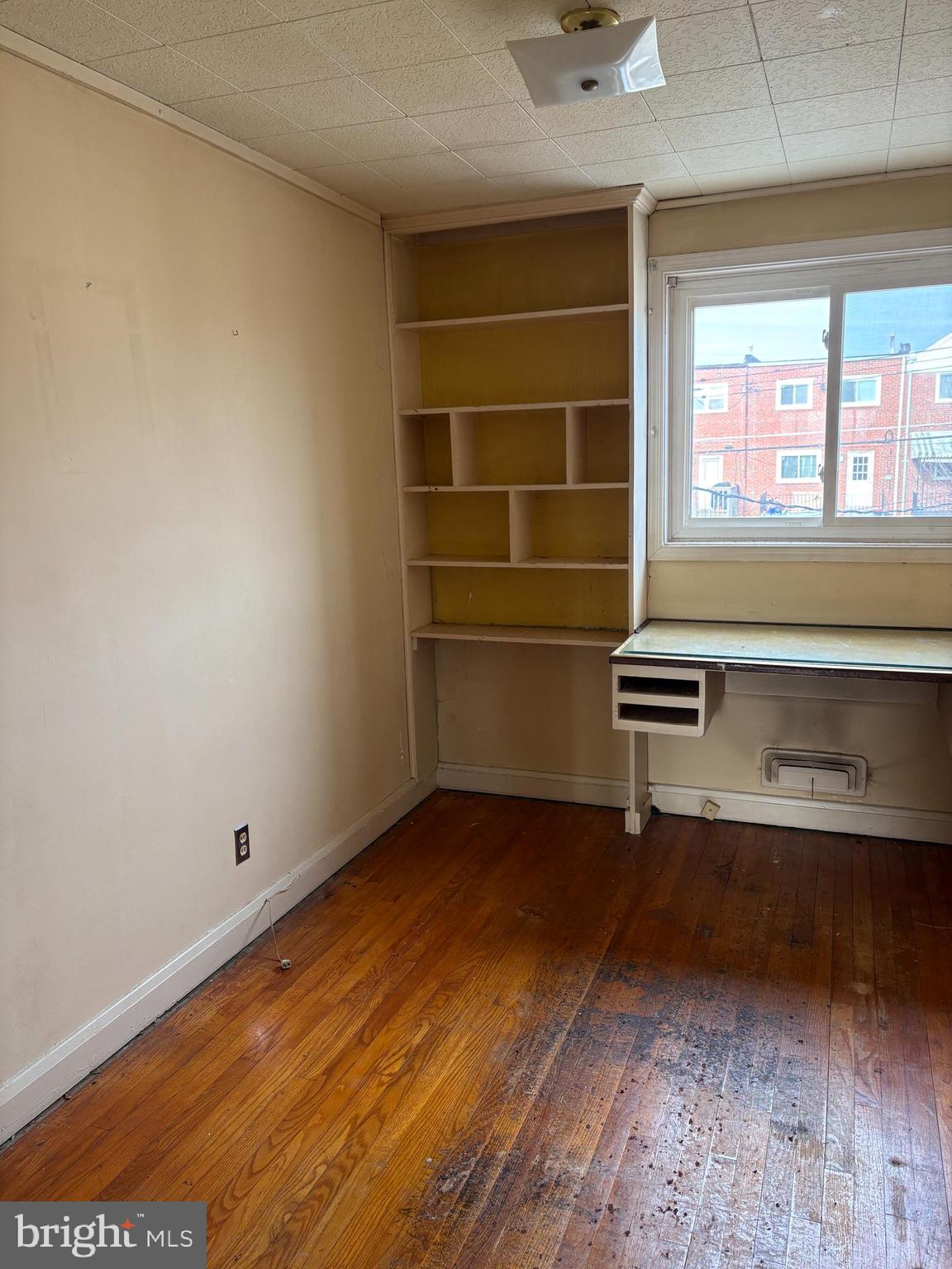 7832 Rockbourne Road Baltimore, MD 21222 - Photo 8 of 20 a view of room with a ceiling fan and wooden floor