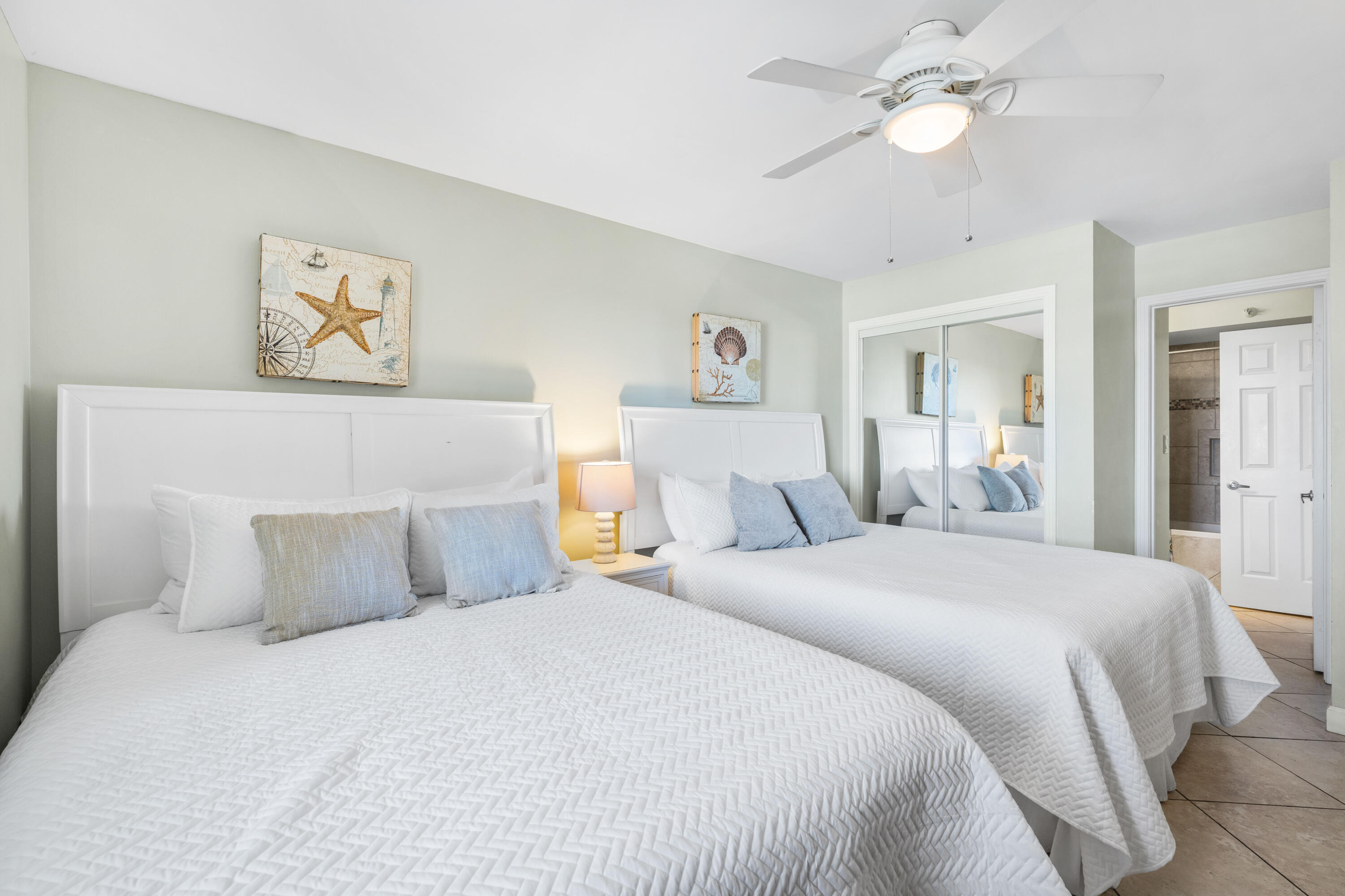 9815 Highway 98, Unit A1506 Miramar Beach, FL 32550 - Photo 16 of 44 a bedroom with a large bed and a chandelier