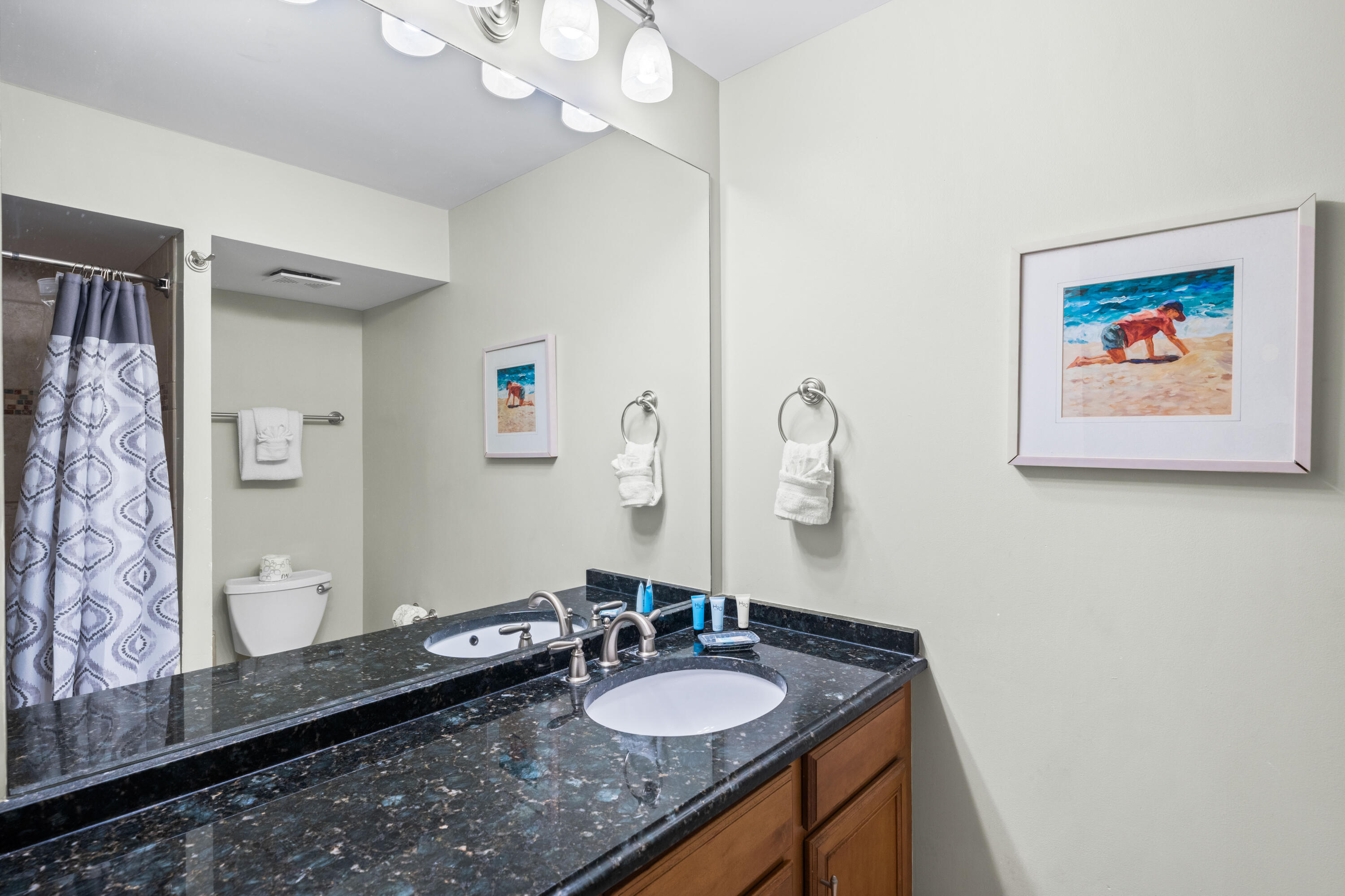 9815 Highway 98, Unit A1506 Miramar Beach, FL 32550 - Photo 17 of 44 a bathroom with a granite countertop sink a mirror and vanity