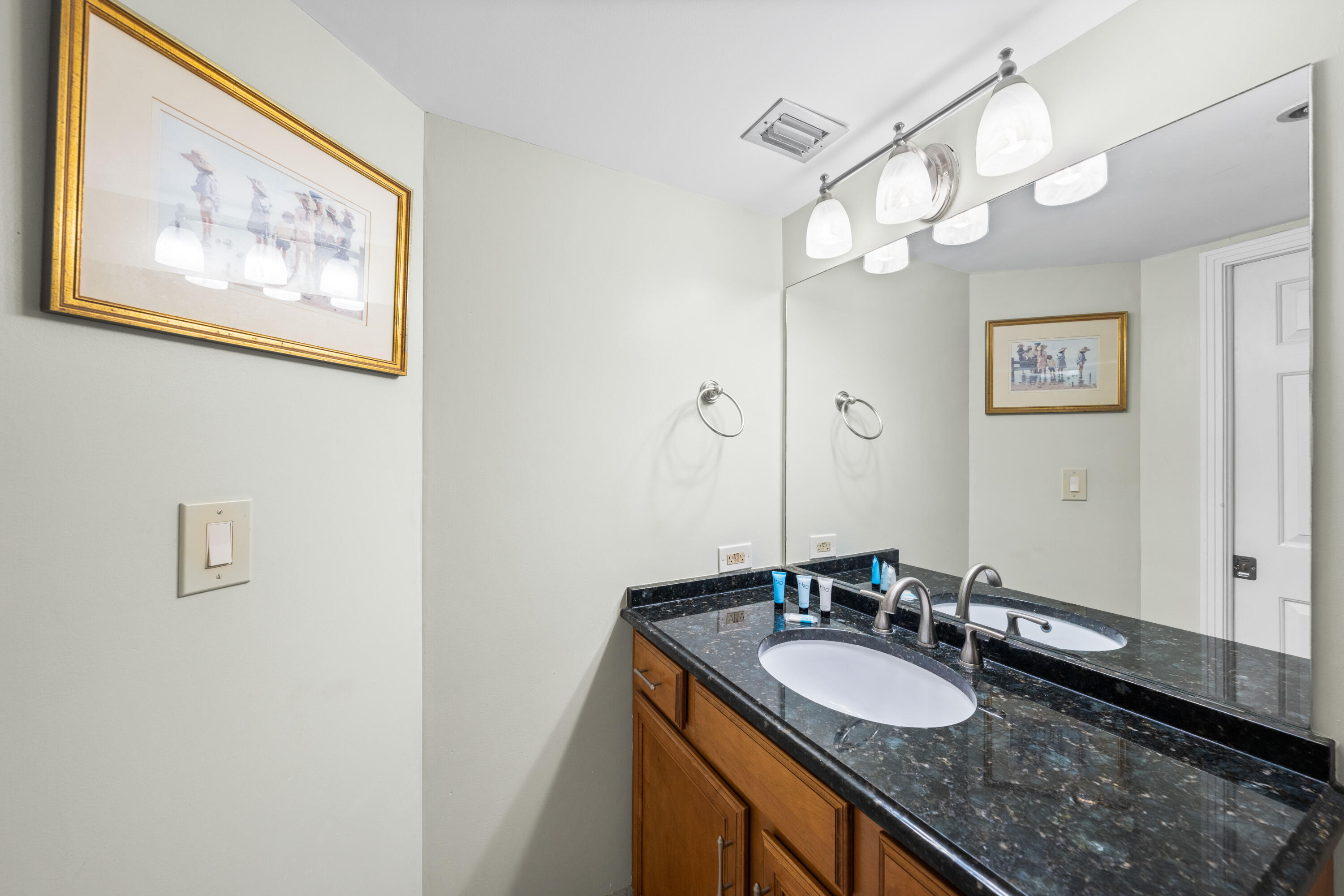 9815 Highway 98, Unit A1506 Miramar Beach, FL 32550 - Photo 22 of 44 a bathroom with a granite countertop sink and a mirror