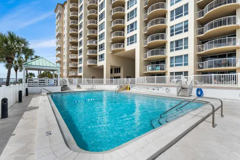 a view of a swimming pool with a lounge chair
